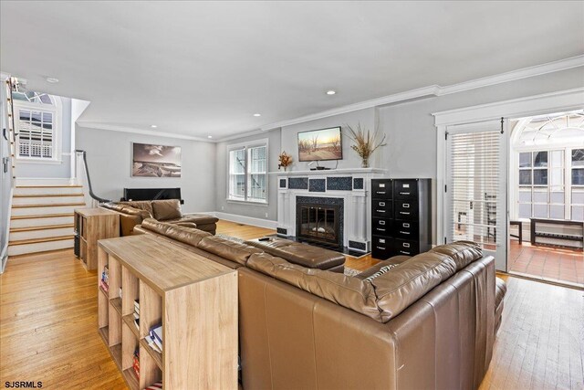 103 S Austin Ave, Ventnor, NJ 08406 - living room featuring a premium fireplace, light wood-type flooring, crown molding, and stairs
