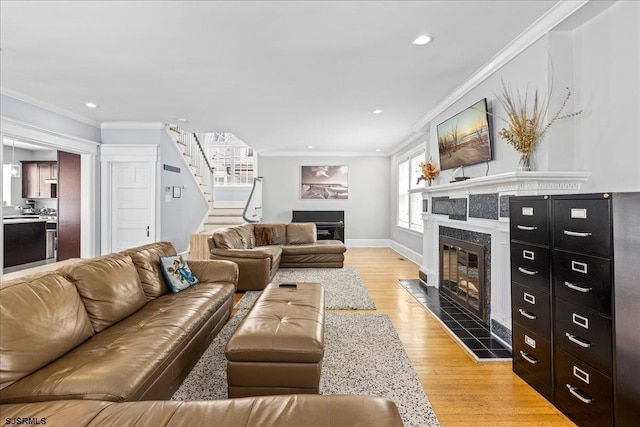 103 S Austin Ave, Ventnor, NJ 08406 - living room with a tile fireplace, crown molding, stairway, light wood-style flooring, and baseboards