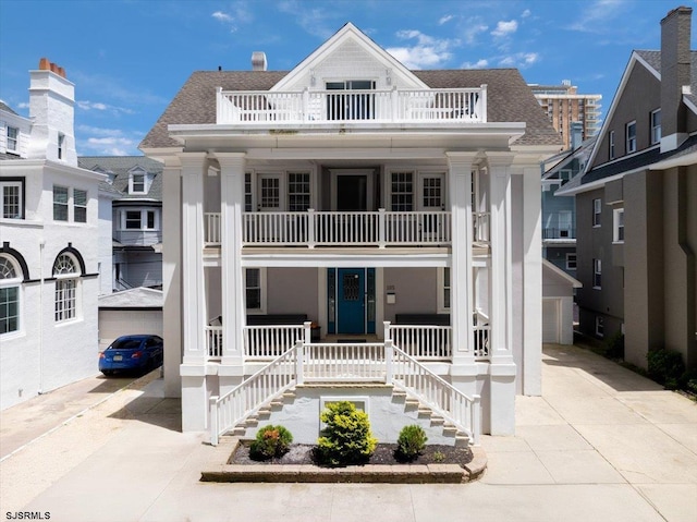 105 S Austin Ave, Ventnor, NJ 08406 - neoclassical home with a balcony, covered porch, concrete driveway, roof with shingles, and stairs