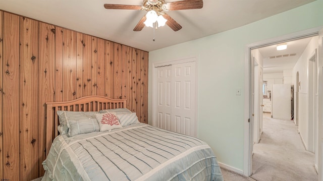 205 Ridgewood Dr, Northfield, NJ 08225 - bedroom featuring light carpet, a closet, freestanding refrigerator, wooden walls, and ceiling fan