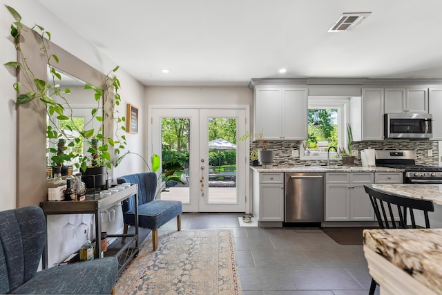 112 Drexel Ave, Egg Harbor Township, NJ 08234 - kitchen featuring stainless steel appliances, decorative backsplash, light stone countertops, french doors, and a sink