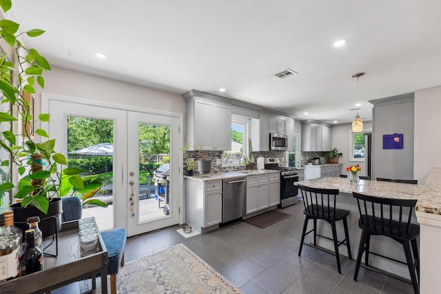 112 Drexel Ave, Egg Harbor Township, NJ 08234 - kitchen with stainless steel appliances, a sink, gray cabinetry, a breakfast bar area, and tasteful backsplash