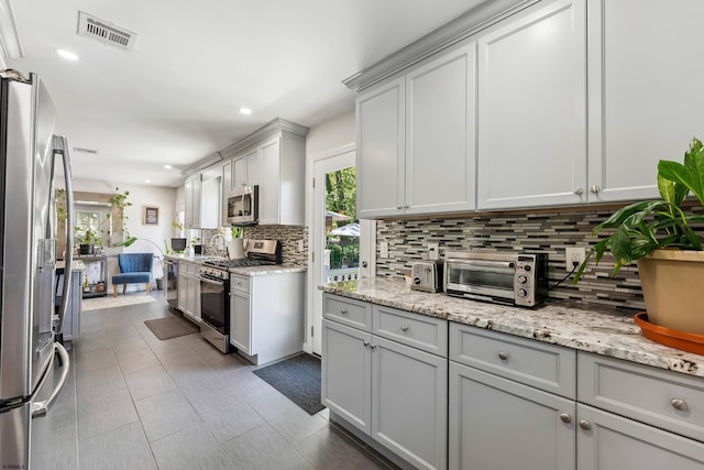 112 Drexel Ave, Egg Harbor Township, NJ 08234 - kitchen with appliances with stainless steel finishes, decorative backsplash, recessed lighting, light stone counters, and gray cabinets
