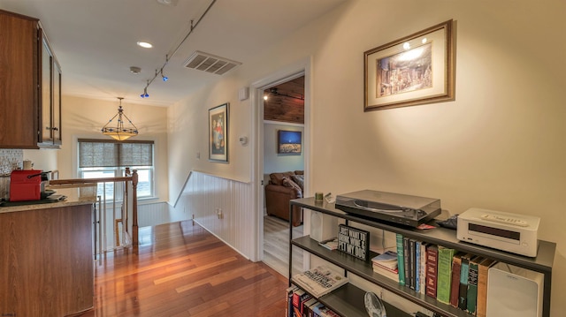8201 Amherst, Margate, NJ 08401 - hall with a wainscoted wall, wood finished floors, an upstairs landing, and rail lighting