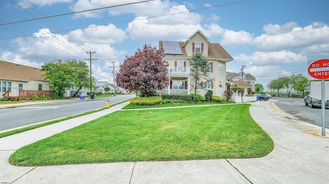 8201 Amherst, Margate, NJ 08401 - view of front facade with roof mounted solar panels and a front lawn