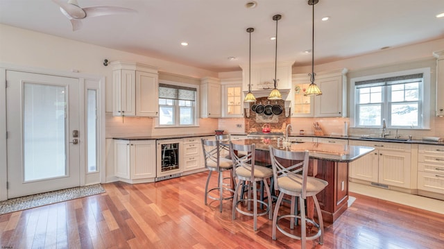 8201 Amherst, Margate, NJ 08401 - kitchen featuring beverage cooler, a sink, plenty of natural light, a breakfast bar, and recessed lighting