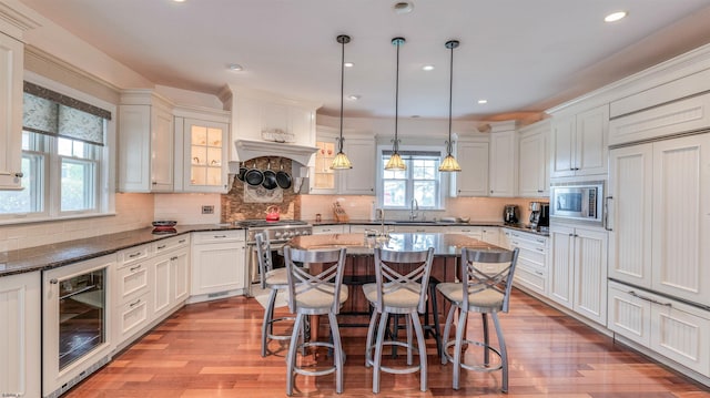 8201 Amherst, Margate, NJ 08401 - kitchen featuring beverage cooler, appliances with stainless steel finishes, light wood-type flooring, a breakfast bar, and recessed lighting