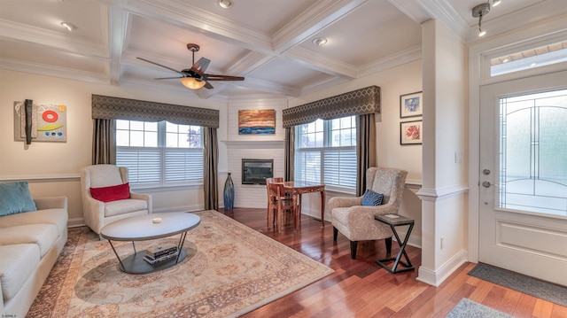8201 Amherst, Margate, NJ 08401 - living area featuring healthy amount of natural light, wood finished floors, a large fireplace, baseboards, and beamed ceiling