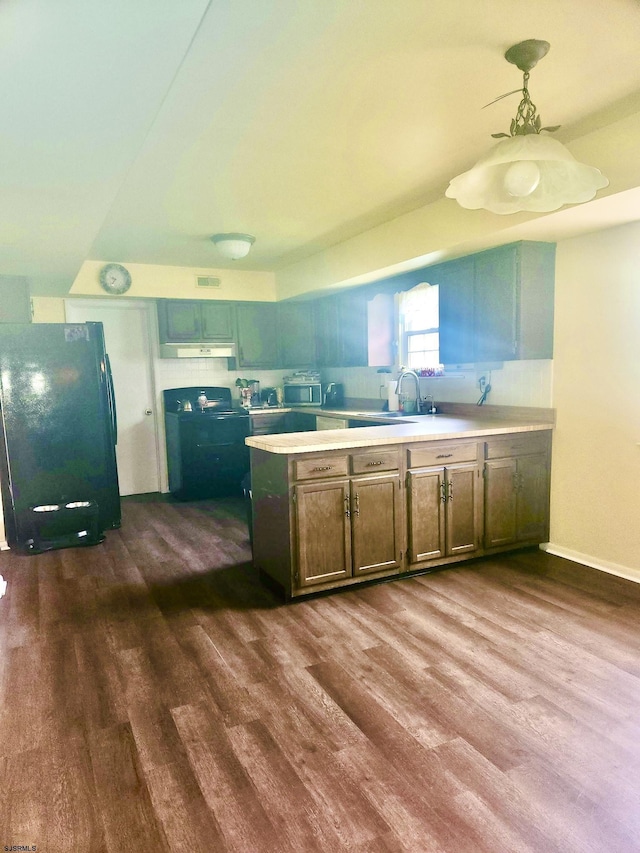 2 King William, Sewell, NJ 08080 - kitchen with freestanding refrigerator, dark wood-style floors, stainless steel microwave, under cabinet range hood, and light countertops