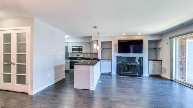 903 Harbour Cv Unit 903, Somers Point, NJ 08244 - kitchen with appliances with stainless steel finishes, dark countertops, open floor plan, dark wood finished floors, and baseboards