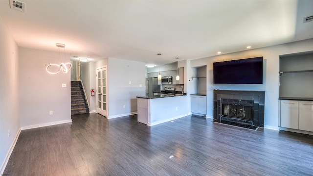 903 Harbour Cv Unit 903, Somers Point, NJ 08244 - unfurnished living room with stairs, dark wood-type flooring, baseboards, a fireplace with flush hearth, and recessed lighting