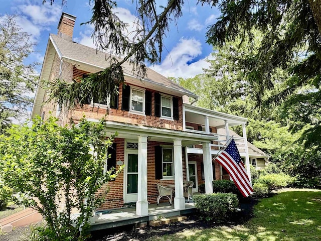 622 Central Ave, Linwood, NJ 08221 - view of front facade with a porch, brick siding, a chimney, and a front yard