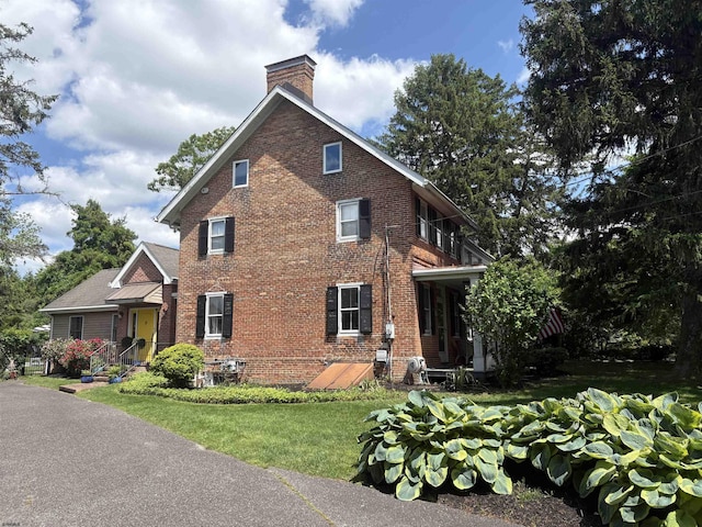 622 Central Ave, Linwood, NJ 08221 - view of front of home featuring brick siding, a chimney, and a front lawn