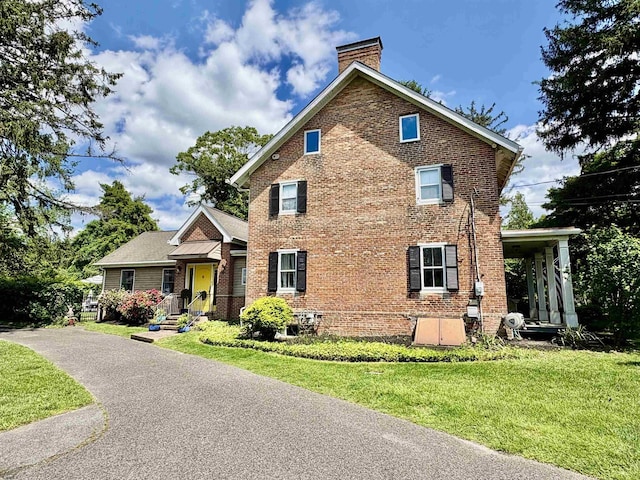 622 Central Ave, Linwood, NJ 08221 - view of front of house with a chimney, brick siding, and a front yard