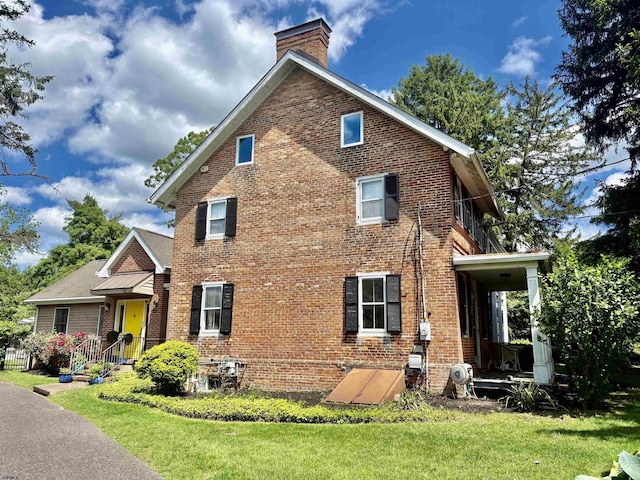 622 Central Ave, Linwood, NJ 08221 - view of side of property featuring brick siding, a chimney, and a yard