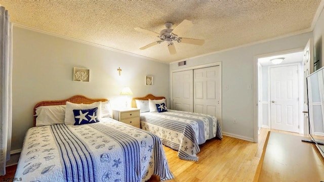 4540 W Brigantine Ave Unit N208, Brigantine, NJ 08203 - bedroom with light wood-type flooring, ornamental molding, a closet, a textured ceiling, and ceiling fan