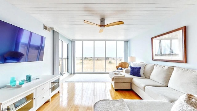 4540 W Brigantine Ave Unit N208, Brigantine, NJ 08203 - living area featuring expansive windows, light wood-style flooring, and a ceiling fan