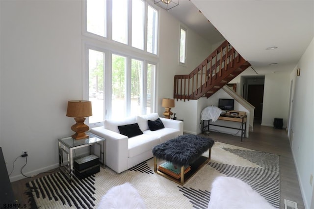 200 Linda Ln, Galloway Township, NJ 08205 - living area with stairs, light wood-style floors, baseboards, and a towering ceiling