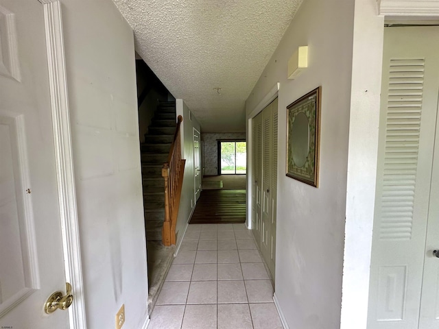 232 E Colman Pl, Galloway Township, NJ 08205 - hall with light tile patterned flooring, a textured ceiling, and baseboards