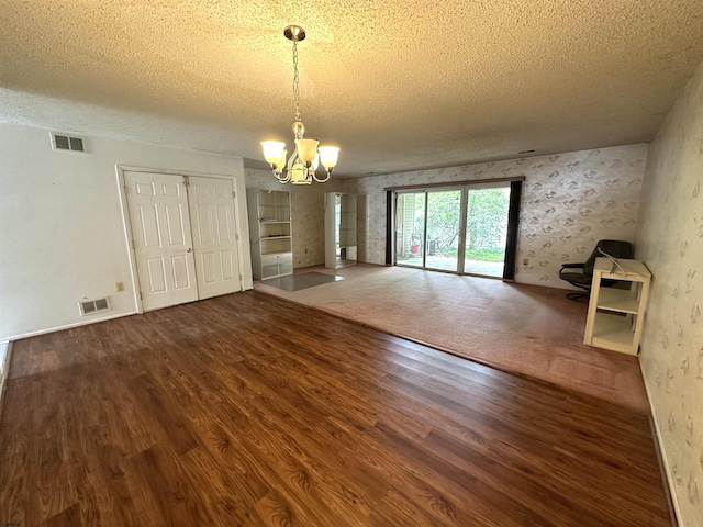 232 E Colman Pl, Galloway Township, NJ 08205 - unfurnished dining area featuring a chandelier, a textured ceiling, and wood finished floors