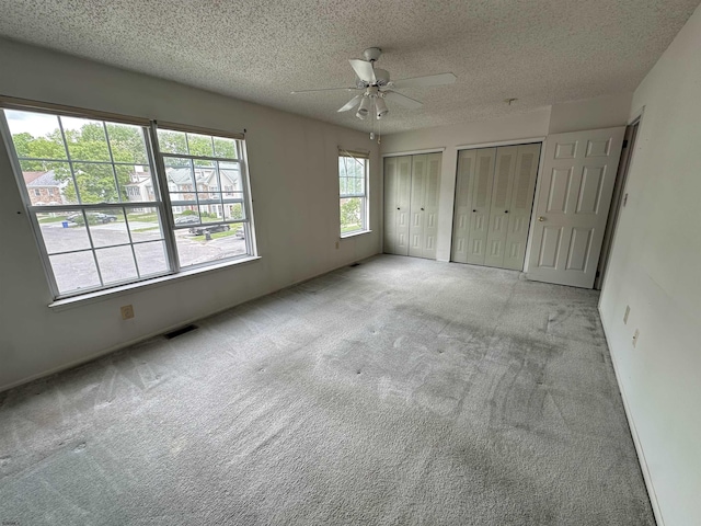 232 E Colman Pl, Galloway Township, NJ 08205 - unfurnished bedroom with two closets, carpet floors, a textured ceiling, and ceiling fan