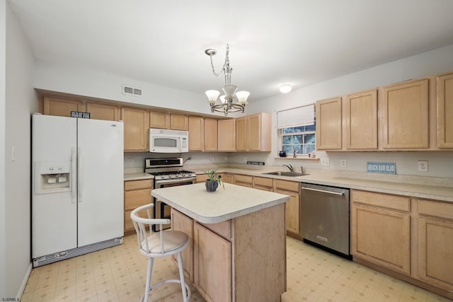 101 Sycamore Ave, Egg Harbor Township, NJ 08234 - kitchen featuring appliances with stainless steel finishes, light brown cabinetry, light flooring, and a chandelier