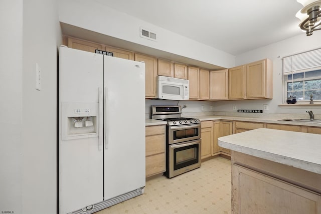 101 Sycamore Ave, Egg Harbor Township, NJ 08234 - kitchen featuring white appliances, light brown cabinetry, a sink, light flooring, and light countertops