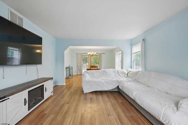 101 Sycamore Ave, Egg Harbor Township, NJ 08234 - living room featuring a chandelier, light wood-style floors, arched walkways, and baseboards