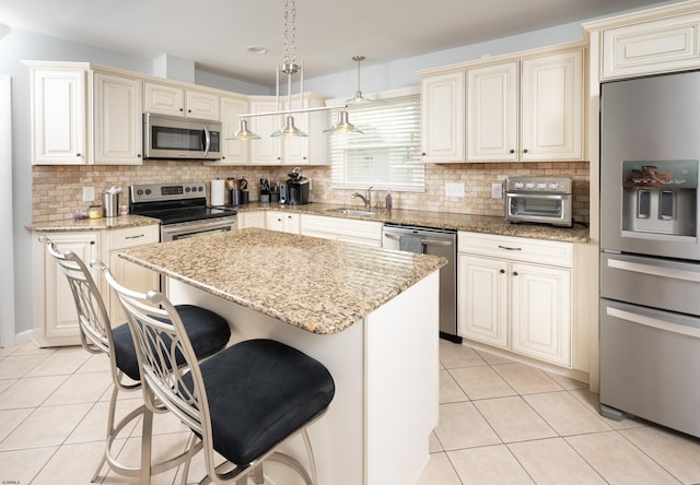 608 Delavan Ave, Margate, NJ 08402 - kitchen featuring appliances with stainless steel finishes, a sink, light tile patterned flooring, cream cabinetry, and recessed lighting