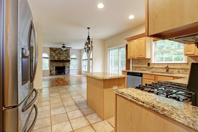2511 Long Ave, Mays Landing, NJ 08330 - kitchen with appliances with stainless steel finishes, light brown cabinetry, tasteful backsplash, light stone countertops, and a fireplace