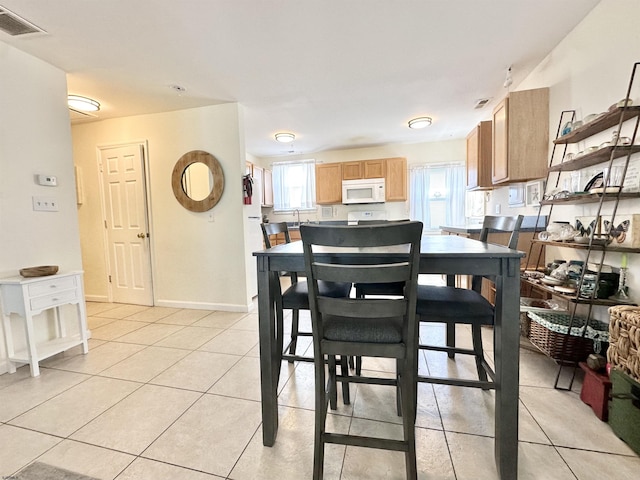 251 38th St, Brigantine, NJ 08203 - dining area featuring light tile patterned floors and baseboards