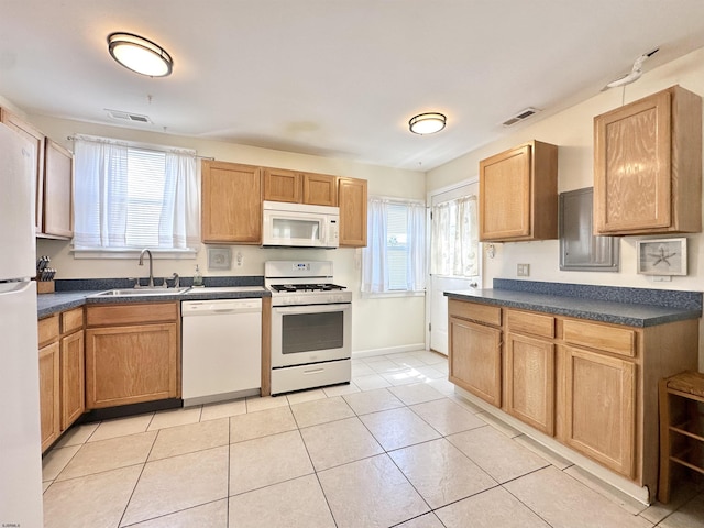 251 38th St, Brigantine, NJ 08203 - kitchen featuring white appliances, a sink, dark countertops, light tile patterned floors, and baseboards