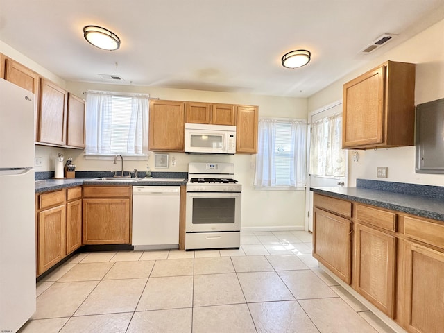 251 38th St, Brigantine, NJ 08203 - kitchen with white appliances, a sink, healthy amount of natural light, and dark countertops