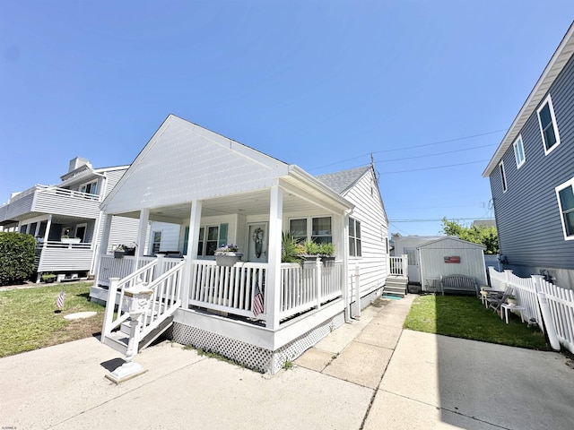 251 38th St, Brigantine, NJ 08203 - view of front of house featuring covered porch and an outbuilding