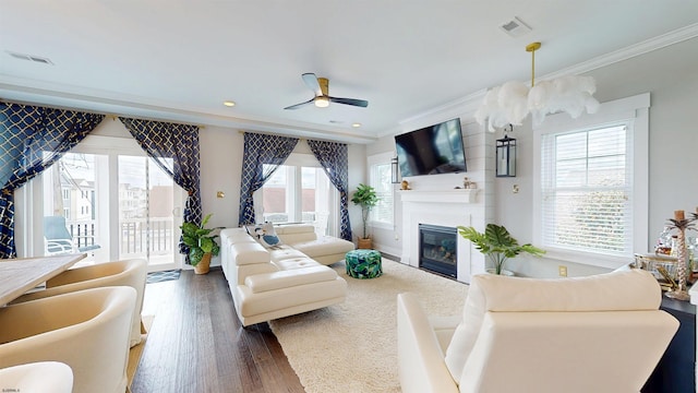 305 15th St, Ocean City, NJ 08226 - living area featuring ornamental molding, plenty of natural light, a large fireplace, wood finished floors, and ceiling fan