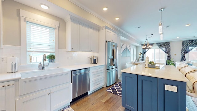 305 15th St, Ocean City, NJ 08226 - kitchen with stainless steel appliances, open floor plan, white cabinets, light wood-style floors, and backsplash