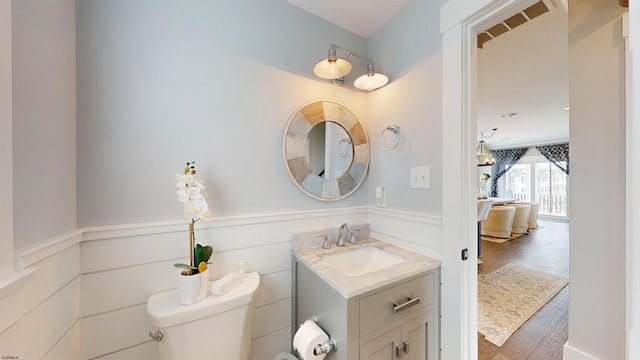 305 15th St, Ocean City, NJ 08226 - half bath with vanity, a wainscoted wall, toilet, and wood finished floors