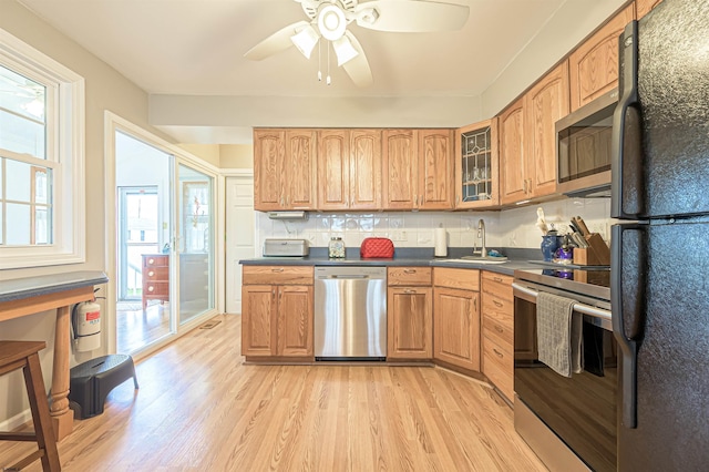 510 Lafayette Blvd, Brigantine, NJ 08203 - kitchen featuring stainless steel appliances, a sink, dark countertops, light wood finished floors, and a ceiling fan