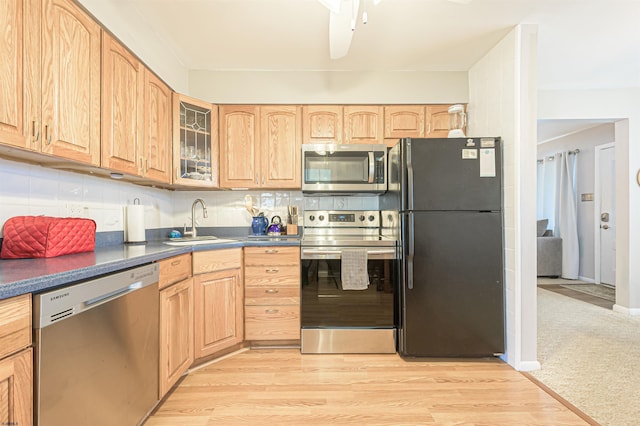 510 Lafayette Blvd, Brigantine, NJ 08203 - kitchen with stainless steel appliances, a sink, dark countertops, glass insert cabinets, and light brown cabinets