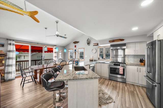 36 S Inlet Dr Unit 2, Ocean City, NJ 08226 - kitchen featuring appliances with stainless steel finishes, a sink, a peninsula, a ceiling fan, and light wood-style flooring
