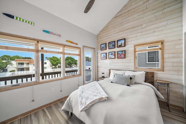 36 S Inlet Dr Unit 2, Ocean City, NJ 08226 - bedroom featuring high vaulted ceiling, wooden walls, wood finished floors, access to outside, and a ceiling fan