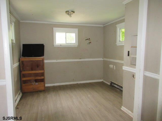 1412 W Cleveland Ave, Egg Harbor City, NJ 08215 - unfurnished room with ornamental molding, wood finished floors, and baseboards