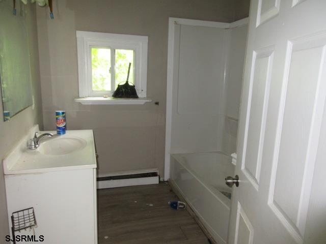 1412 W Cleveland Ave, Egg Harbor City, NJ 08215 - full bathroom featuring a baseboard heating unit, vanity, and wood finished floors