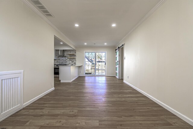110 Seaside Ave, Egg Harbor Township, NJ 08234 - unfurnished living room with ornamental molding, recessed lighting, dark wood-style floors, a barn door, and baseboards