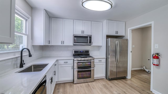 11 Carann Ln, Egg Harbor Township, NJ 08234 - kitchen with stainless steel appliances, a sink, white cabinetry, light stone countertops, and tasteful backsplash