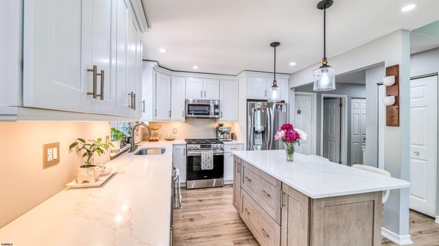 521 Saratoga Pl, Smithville, NJ 08234 - kitchen with stainless steel appliances, a sink, light wood-style flooring, recessed lighting, and light stone counters
