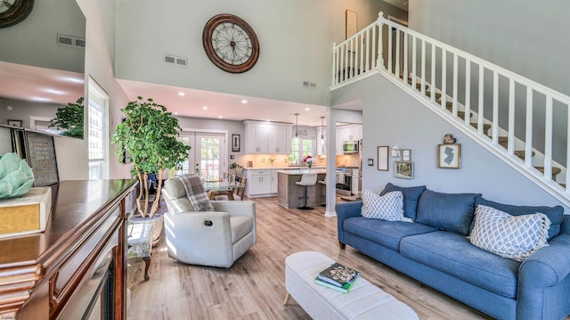521 Saratoga Pl, Smithville, NJ 08234 - living room featuring a high ceiling, light wood finished floors, and stairs