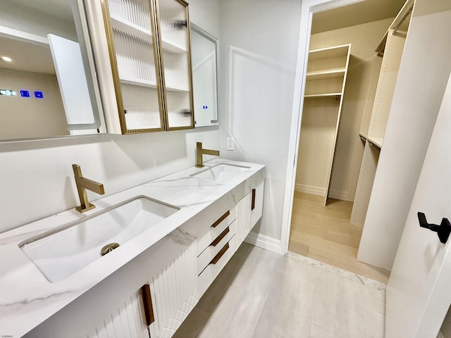 5000 Boardwalk Unit 1617, Ventnor, NJ 08406 - bathroom with double vanity, recessed lighting, a walk in closet, and baseboards
