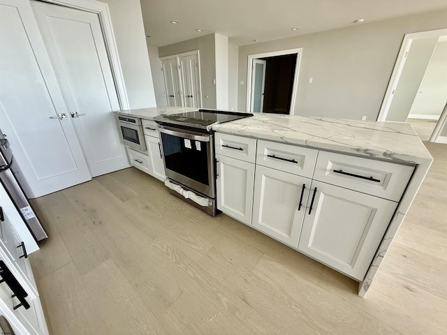 5000 Boardwalk Unit 1617-1616, Ventnor, NJ 08406 - kitchen with electric range, light wood-style floors, light stone countertops, white cabinetry, and recessed lighting