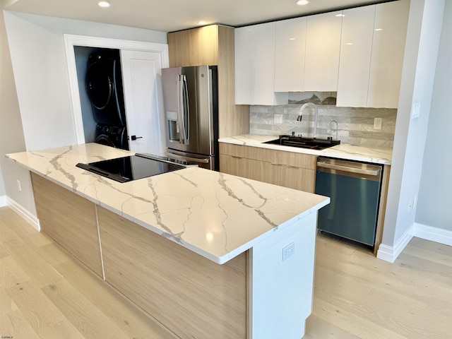 5000 Boardwalk Unit 1617-1616, Ventnor, NJ 08406 - kitchen with stainless steel appliances, stacked washer / drying machine, modern cabinets, a sink, and recessed lighting